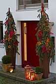 Red front door decorated for Christmas