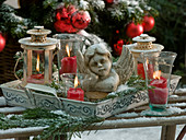 Lightly snowed bust of an angel on a metal tray