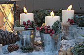 White candles in metal bucket