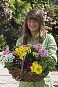 Young woman with basket full of primroses