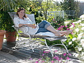 Woman relaxing on a deck chair in the shade