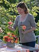 Woman sticks late summer bouquet