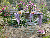 Gedeckter Tisch auf Kiesfläche im Garten