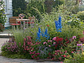 Bed with perennials, summer flowers and grasses