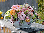 Autumn bouquet of roses in a porcelain vase