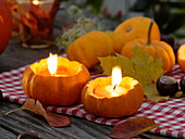 Small ornamental pumpkins as tea light holders