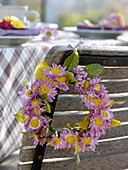 Autumn table decoration with autumn chrysanthemums and Heuchera leaves