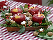 Unusual Christmas wreath with apple candles on square saucer