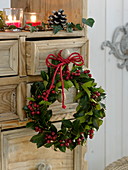 Ilex (Holly) wreath hung on the cabinet