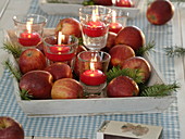 Pre-Christmas decoration with floating candles in glasses on tray