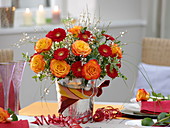 New Year's Eve table decoration with roses and gerbera