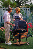Graham NICHOLS AND JANE NICHOLS at THE BARBECUE IN THE NICHOLS Garden, READING