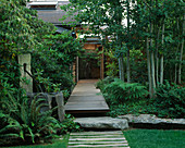 VIEW Along Front WOODEN PATH with LAWN, STONE Water Feature with COPPER Pipe, Rock, DECKING AND ASPENS. Designer Bob SWAIN, Seattle, USA