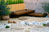 ROOF Garden: BAMBOO FENCE, White Boulders, Red CEDAR DECK AND SEATS, RENDERED WALL with WINDOW AND BESOM BROOM: DESIGN by ALISON WEAR ASSOCIATES