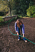 Clare MATTHEWS USING A Hose TO LAY OUT A PATH IN HER Devon Garden