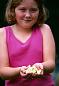Designer: Clare MATTHEWS - RUSTIC BIRD FEEDER - Girl HOLDING CHOPPED APPLES