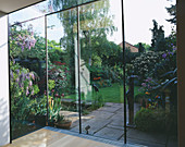 Designer: SHEILA STEDMAN - VIEW From KITCHEN THROUGH GLASS Screen TO Garden BEYOND with SCULPTURE by Helen SINCLAIR