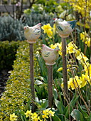 Handmade ceramic birds on cut branches