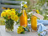 Dandelion syrup in bottles, small Taraxacum bouquet