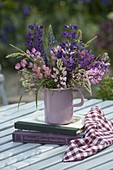 Lupinus polyphyllus and grasses bouquet in enameled jug