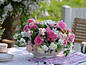 Pink and white scent of roses and Philadelphus coronarius