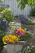 Woman sticks cottage garden bouquet (1/3)