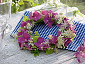 Small wreath of hydrangea (hydrangea) and clematis (clematis)