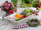 Tray with herbs, herb bouquet and herb wreath