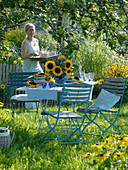 Table decoration with sunflowers under an apple tree