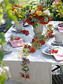 Table decoration with garland of sorbus (rowanberry) and fennel