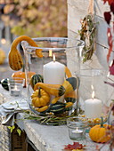 Big glasses as lanterns with pumpkins and corn on the cob