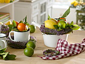 Enamelled pots with (Citrus reticulata), lemons (Citrus limon), limes