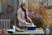 Woman cleans and oils garden tools