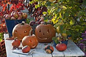 Happy pumpkin heads on wooden table