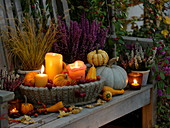 Wide bowl with pumpkins (Cucurbita), Malus (ornamental apples) and candles