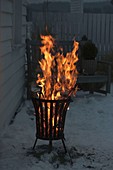Fire basket on terrace in the snow
