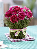 Ranunculus bouquet, vase with Vaccinium branches