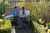 Children with Easter nest in farm garden