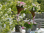 Self made wicker baskets pinned on sticks in metal pots