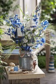 Blue and white bouquet in old zinc pot
