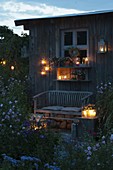 Garden house in the evening lighting with lanterns and lanterns