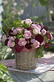 Bouquet of roses, herbs and perennials in basket