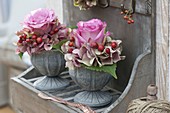 Rosa 'Variance' flowers in small hydrangea wreaths