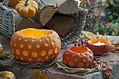 Decorative carved pumpkins (Cucurbita) in wreaths of twigs