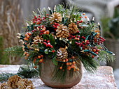 Christmas bouquet with Skimmia (fruit cimmia), bleached cones