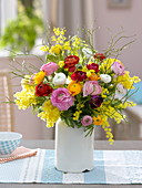 Colorful ranunculus and acacia spring bouquet