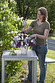 Woman sticks fragrant spring bouquet