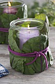 Canning jars as lanterns wrapped with cabbage leaves