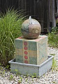 Pottery ball on column as water feature