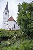 Enchanted garden corner against the wall facing the church